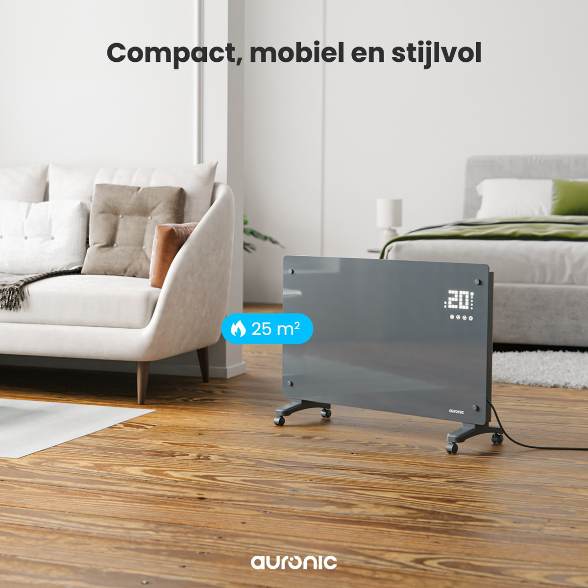 Grijze paneelverwarming in een woonkamer. Bank en bed op de achtergrond. De verwarming heeft een digitaal display.