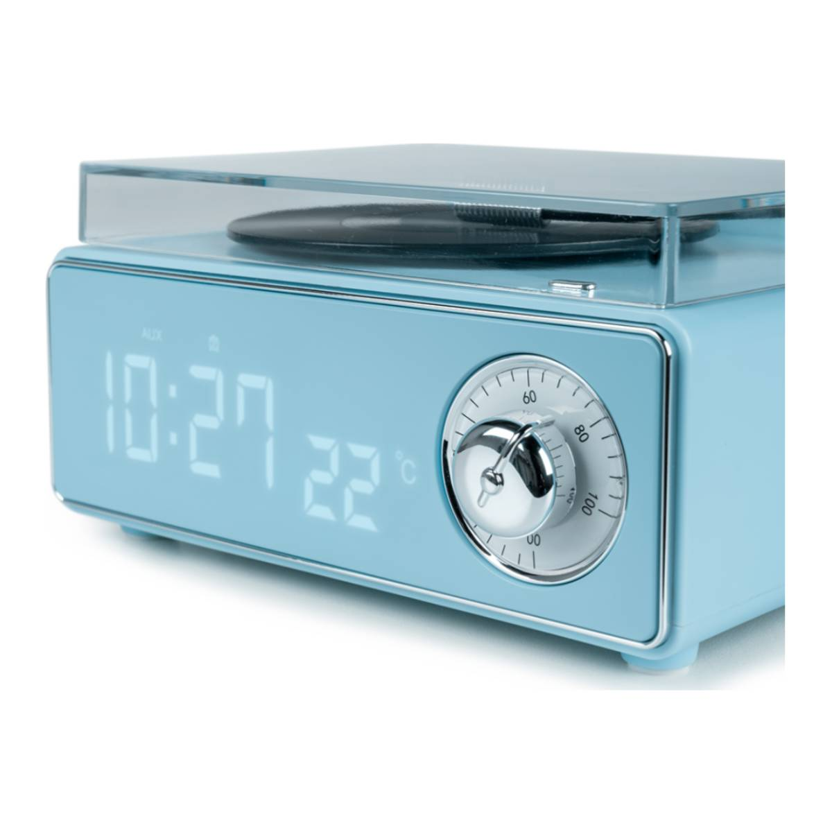 Un radio-réveil bleu de style rétro. Il possède un affichage numérique, un cadran et un haut-parleur. La radio a un dessus transparent.