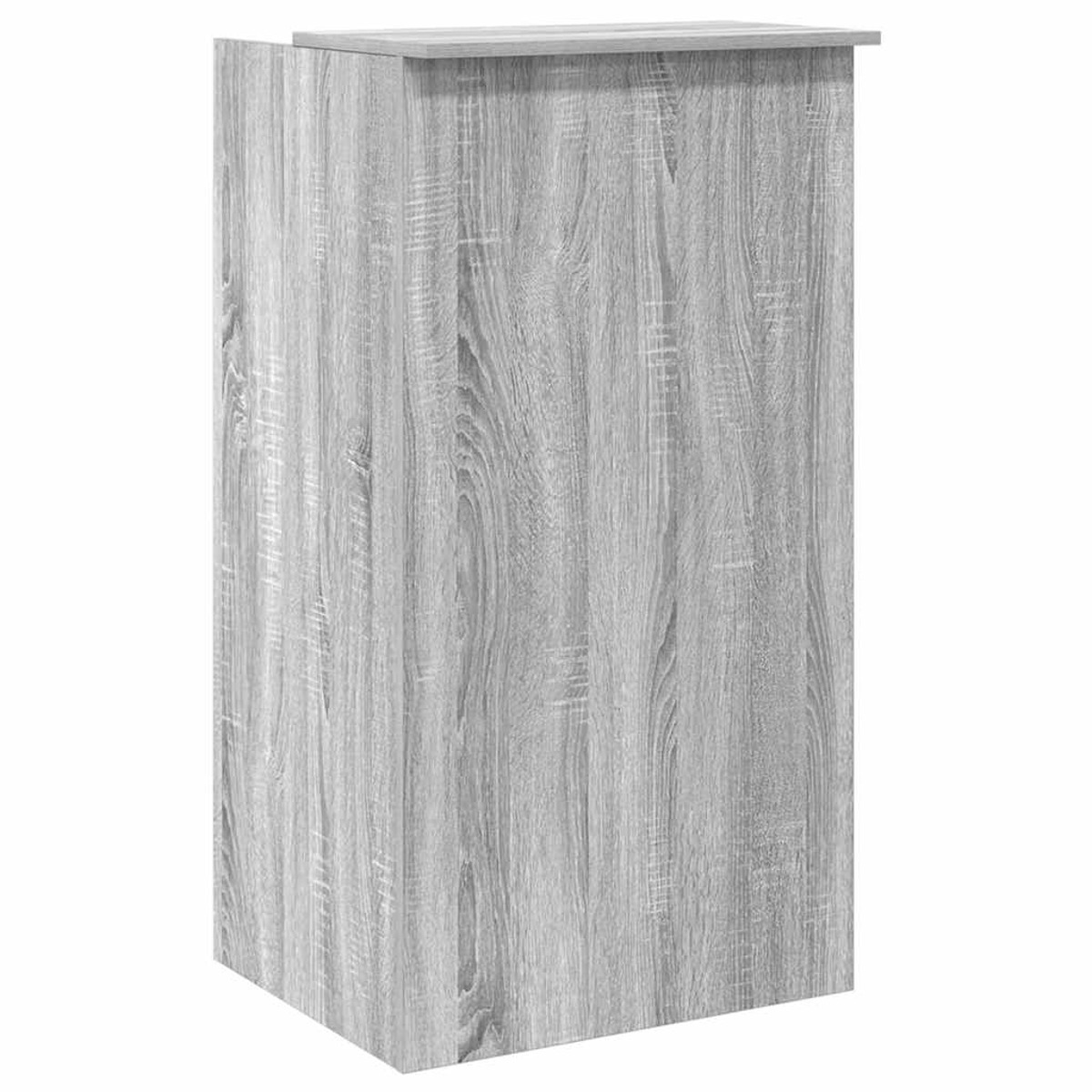 Ein grauer Holzschrank mit flacher Oberseite. Der Schrank hat eine strukturierte Oberfläche.