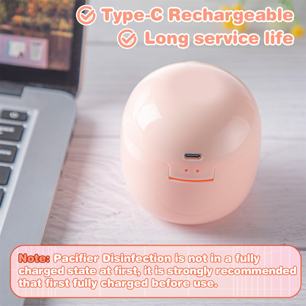 Rosa Schnullersterilisator mit USB-C-Anschluss. Text-Overlay besagt Aufladen und lange Lebensdauer.
