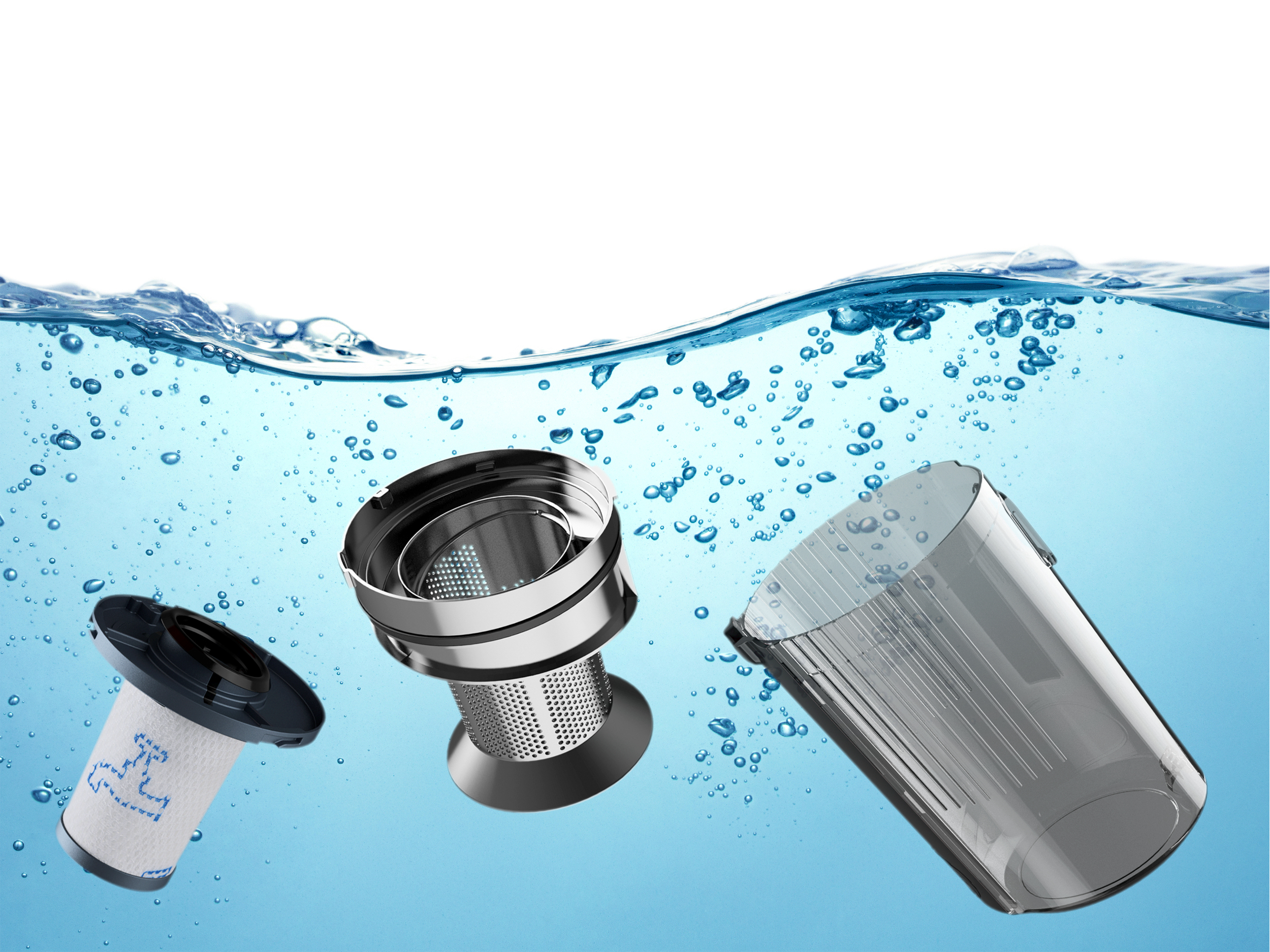 Piezas de aspiradora en agua: filtro, pieza metálica y recipiente transparente.