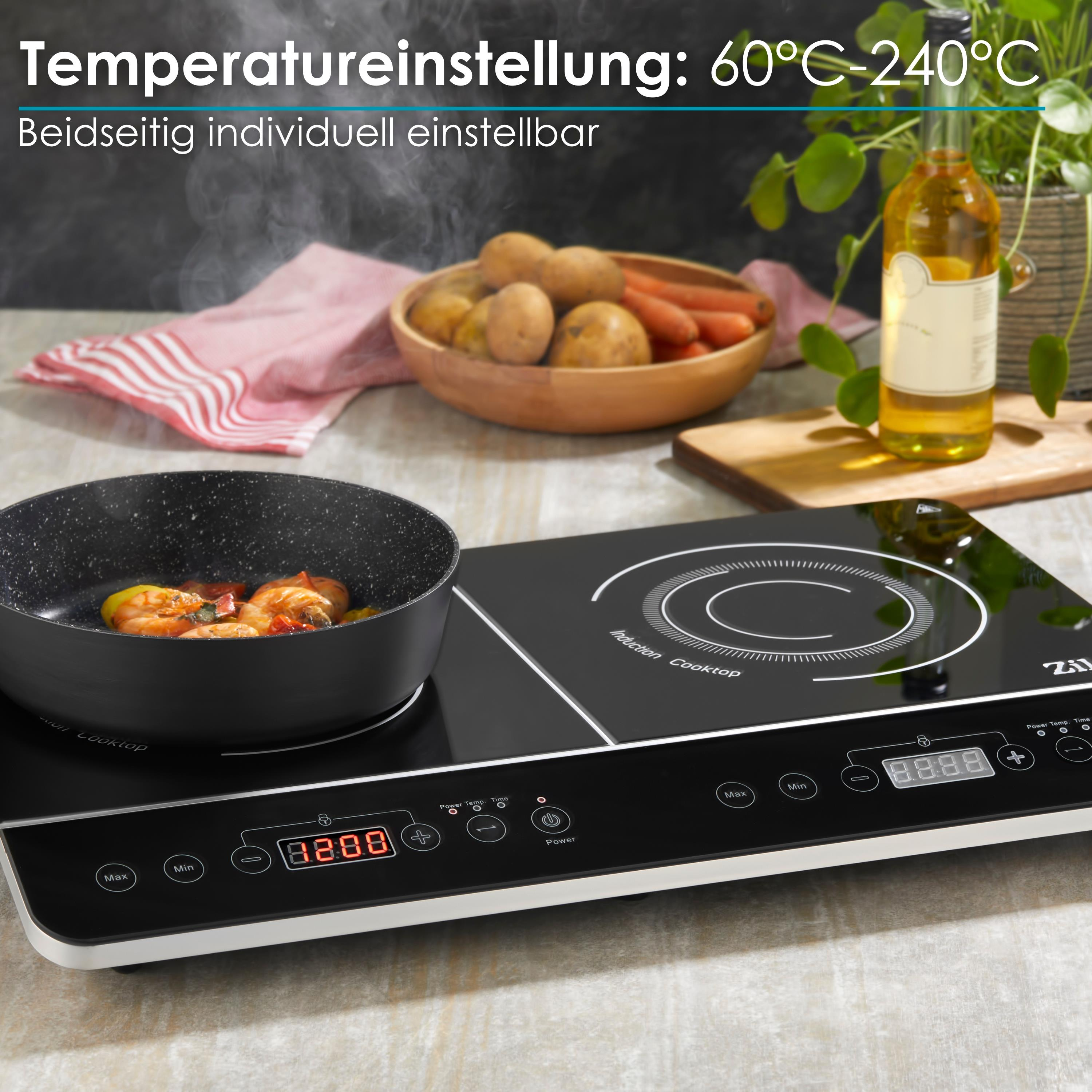 Ein Induktionskochfeld mit kochendem Essen. Es hat eine schwarze Oberfläche mit Touch-Bedienelementen und digitaler Anzeige.