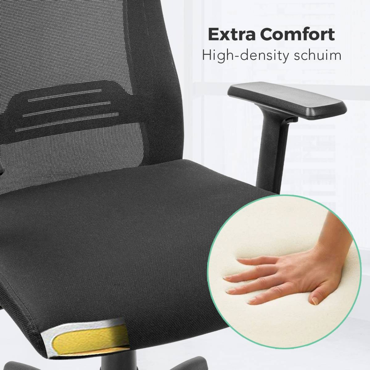 Close-up of a black office chair cushion with high-density foam, hand touching it.