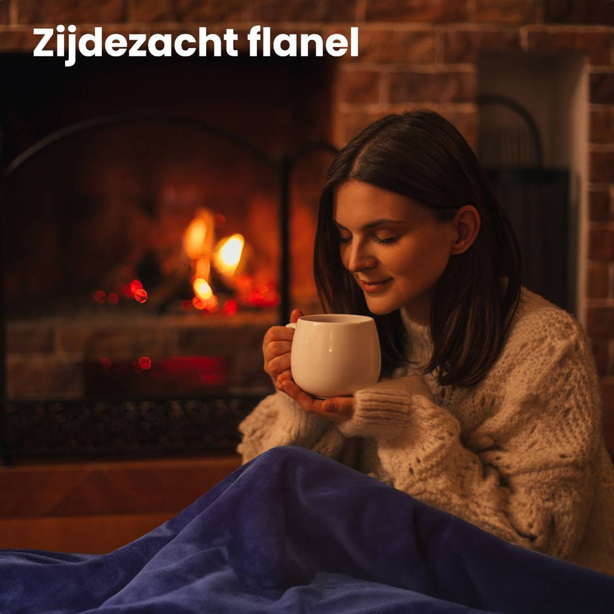 A woman holding a mug by a fireplace, wrapped in a blue blanket. She seems cozy and relaxed.