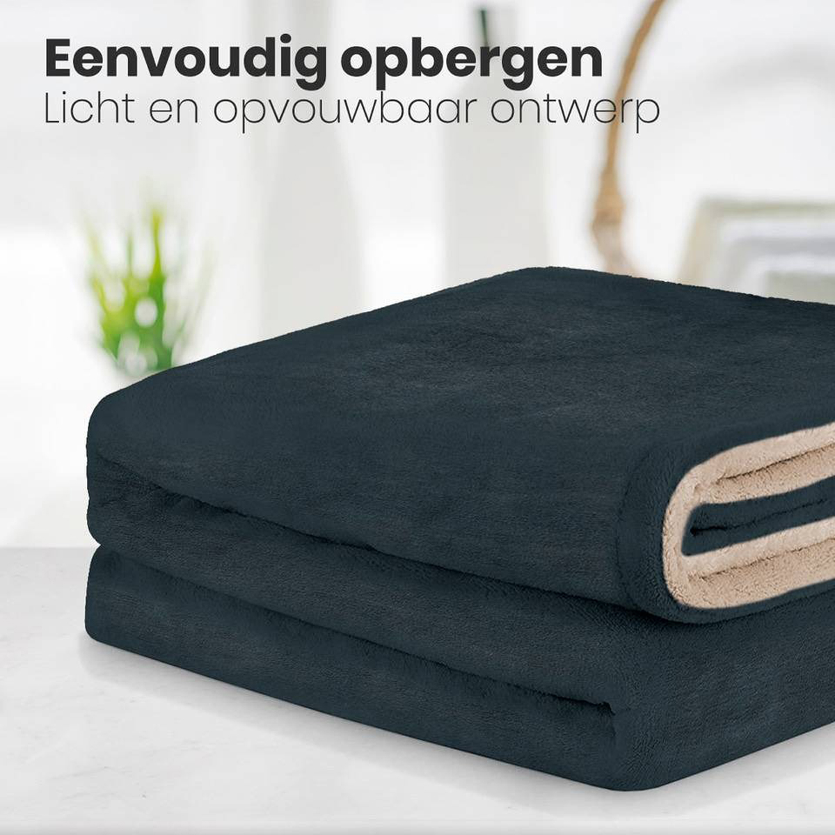 Dark blue folded blanket, with a tan interior, stacked on a surface.