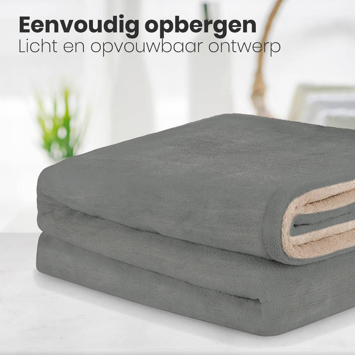 Folded gray blanket on a table, with a light beige interior, promoting easy storage.