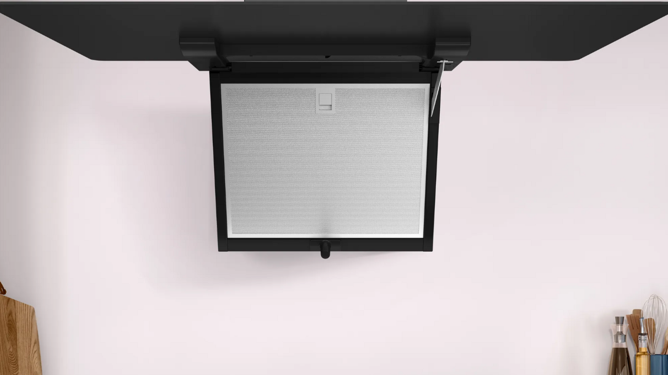 Una cappa da cucina nera, montata su un soffitto bianco.