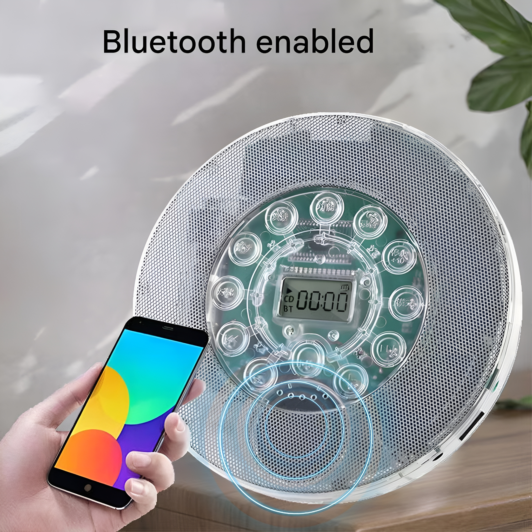Ein weißer und silberner Bluetooth-CD-Player mit Smartphone und farbenfroher Oberfläche.