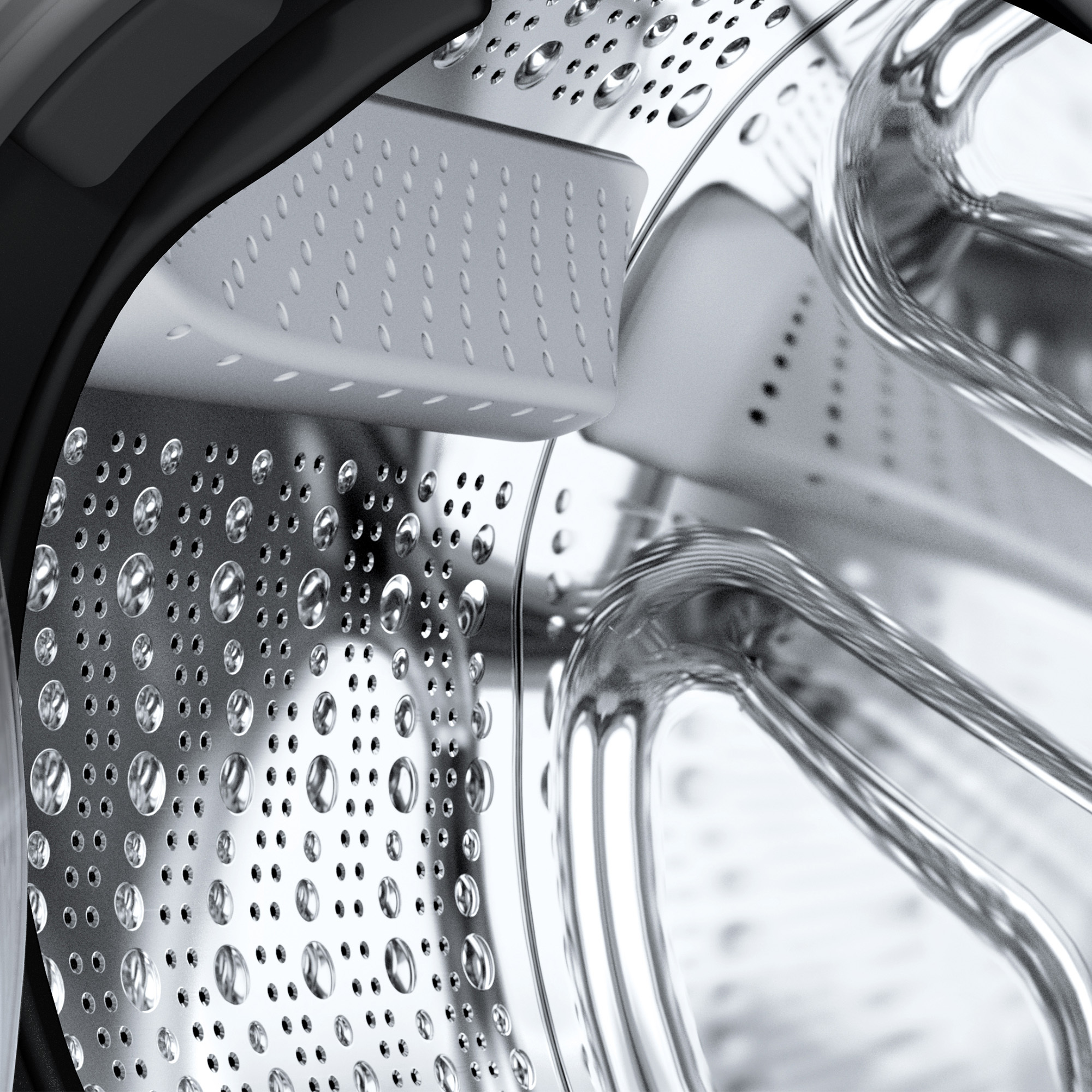 Primo piano dell'interno di un cestello di lavatrice, con goccioline d'acqua.