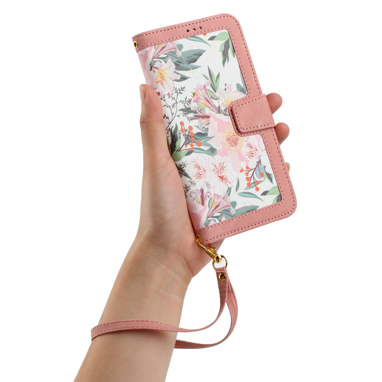 Hand hält eine pinke Handyhülle mit Blumenmuster und Handschlaufe, zeigt das Design.