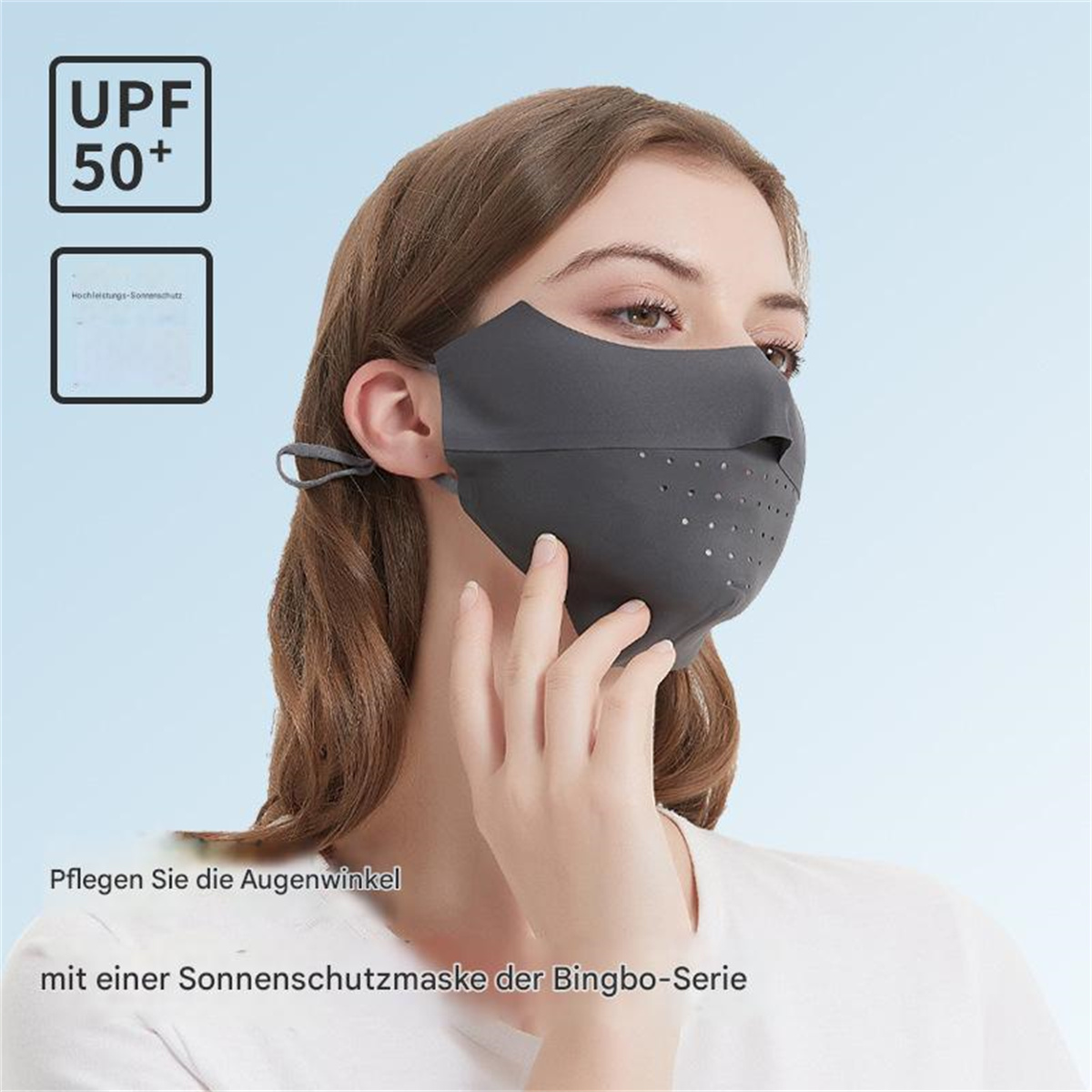 Eine Frau trägt eine graue Gesichtsmaske zum Sonnenschutz mit UPF 50+ Etikett.