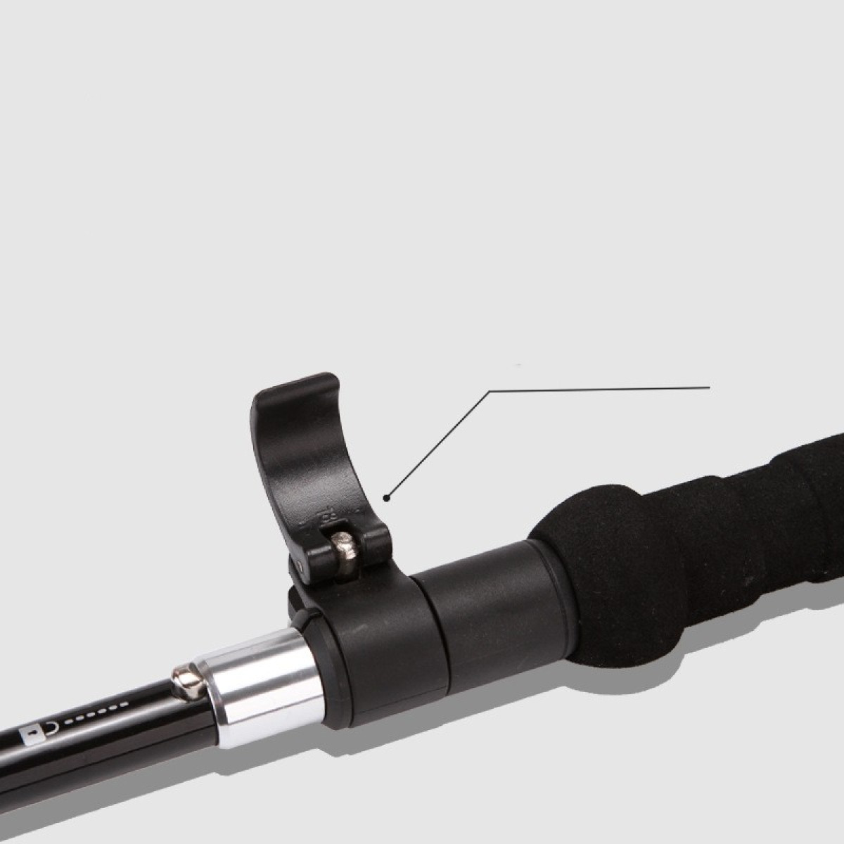 Close-up of a hiking stick handle and locking mechanism. Black handle with a grey accent.
