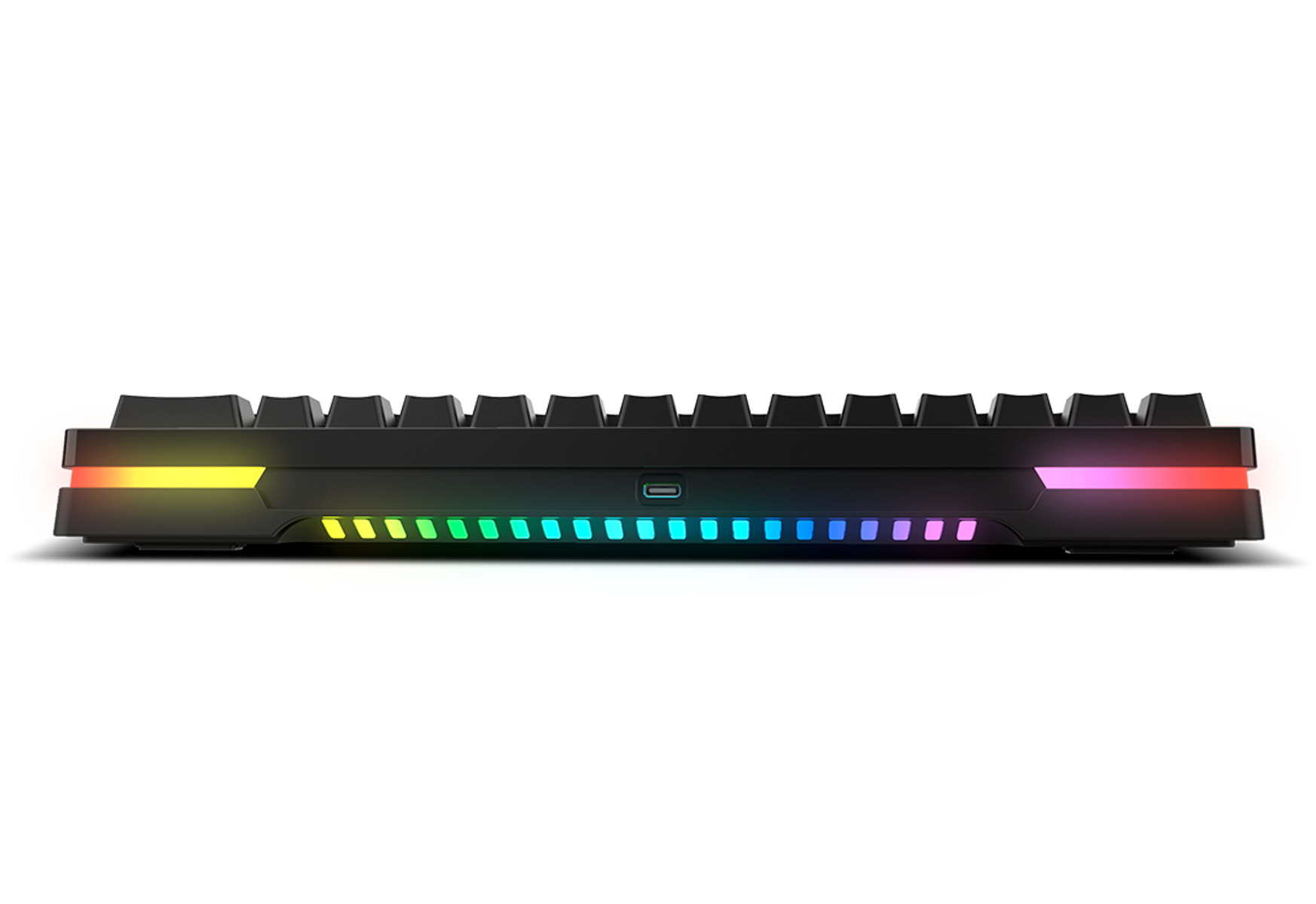 Una tastiera nera con illuminazione RGB sui lati, vista da una bassa angolazione.