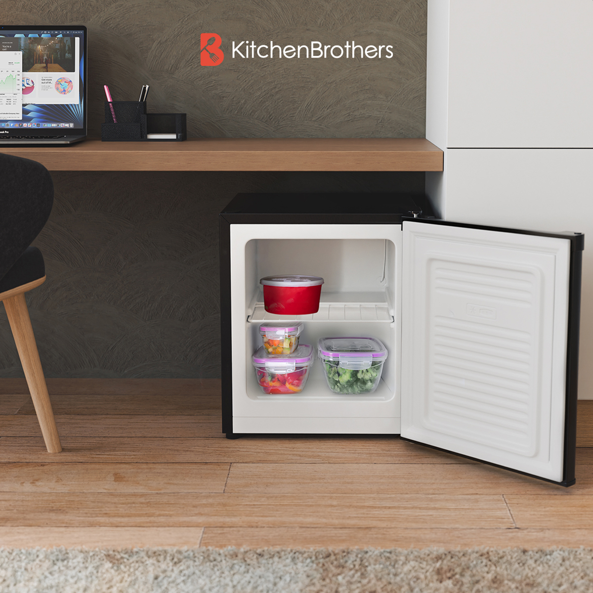 A small black refrigerator is open, showing food containers inside. The brand is KitchenBrothers.