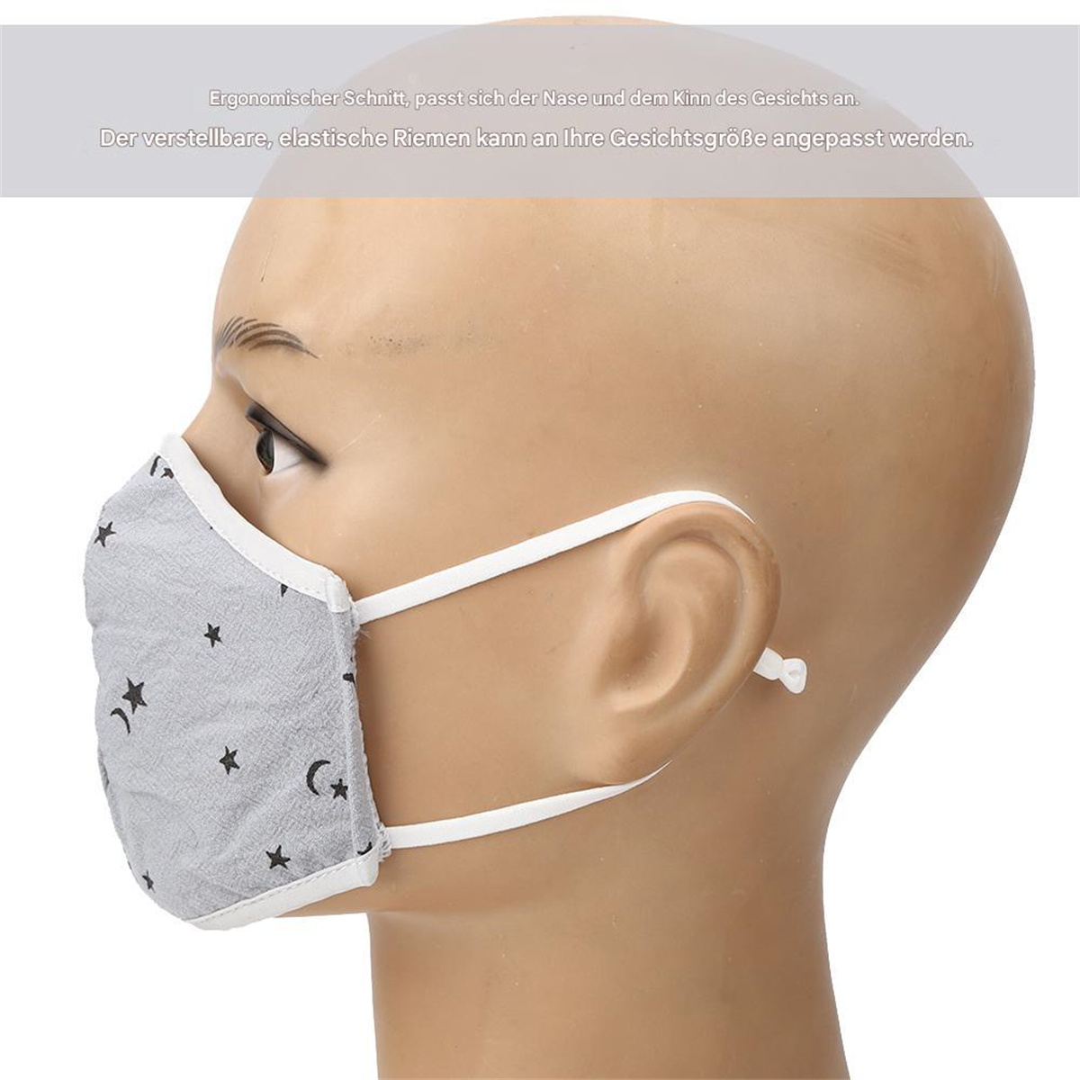 Mannequin, das eine graue Gesichtsmaske mit Stern- und Mondmuster und weißen Trägern trägt. Seitenprofilansicht.