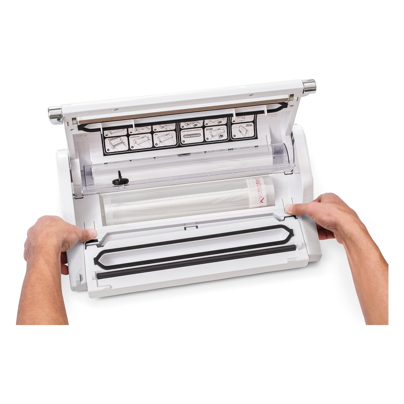 Biała zgrzewarka próżniowa jest otwarta. Dwie dłonie są po bokach, gotowe do zgrzewania.