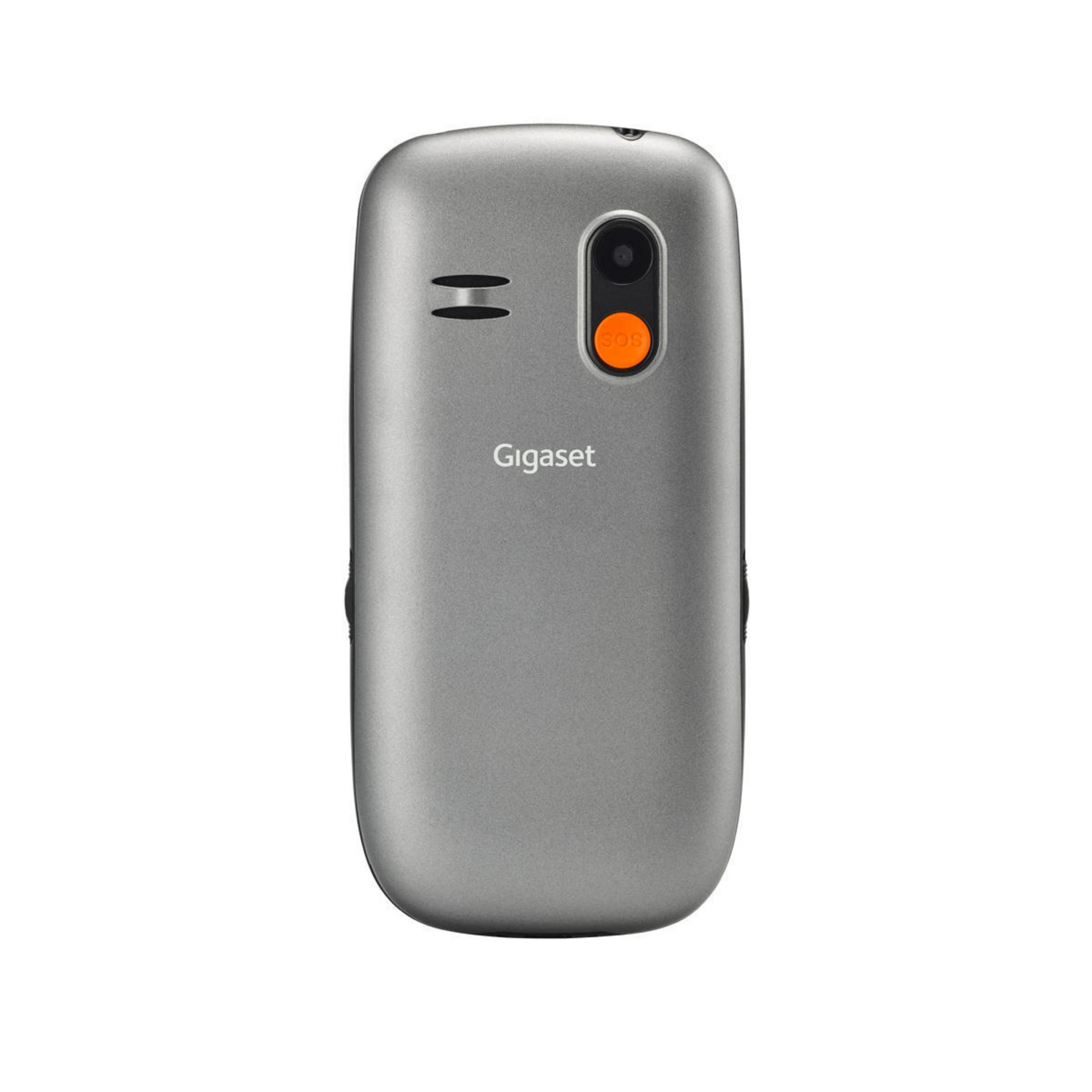 Retro di un telefono Gigaset grigio. Pulsante arancione, dettagli neri. Sfondo bianco.