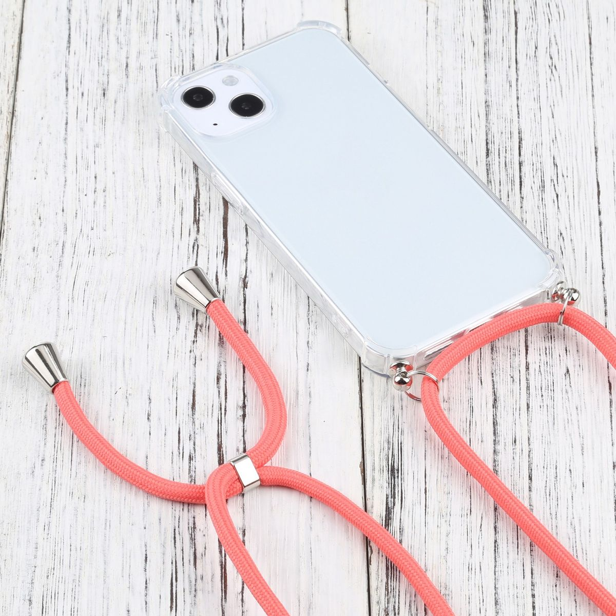 Transparente Handyhülle mit Handy und pinkfarbenem Umhängeband. Das Band hat einen silbernen Metallverschluss.