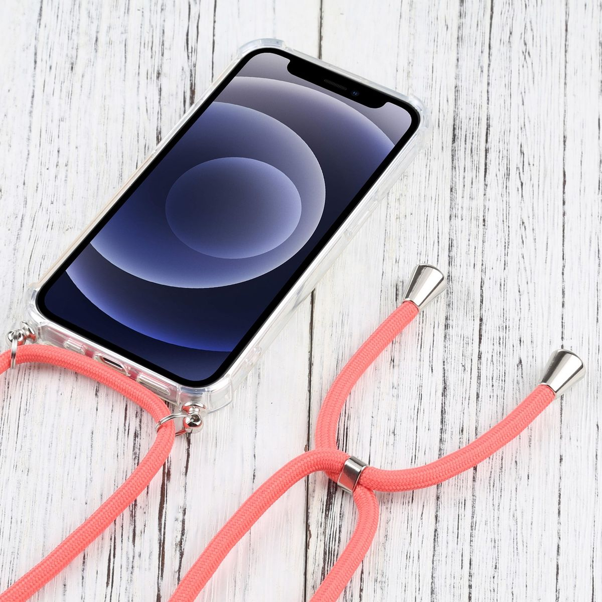 Telefon mit korallenfarbenem Umhängeband auf Holzoberfläche. Klare Hülle.