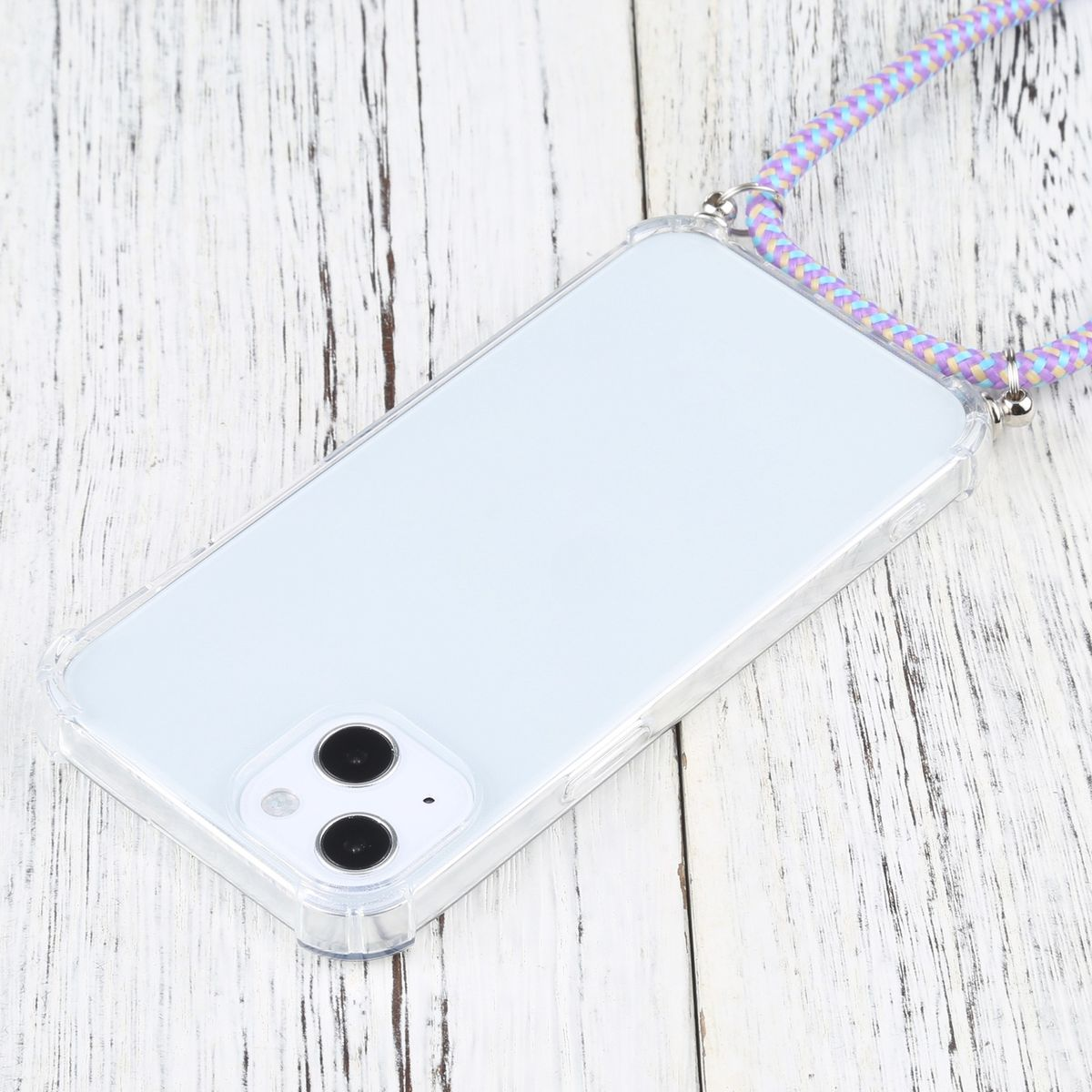 Eine transparente Handyhülle mit Telefon, mehrfarbigem Gurt, auf weißer Holzoberfläche.