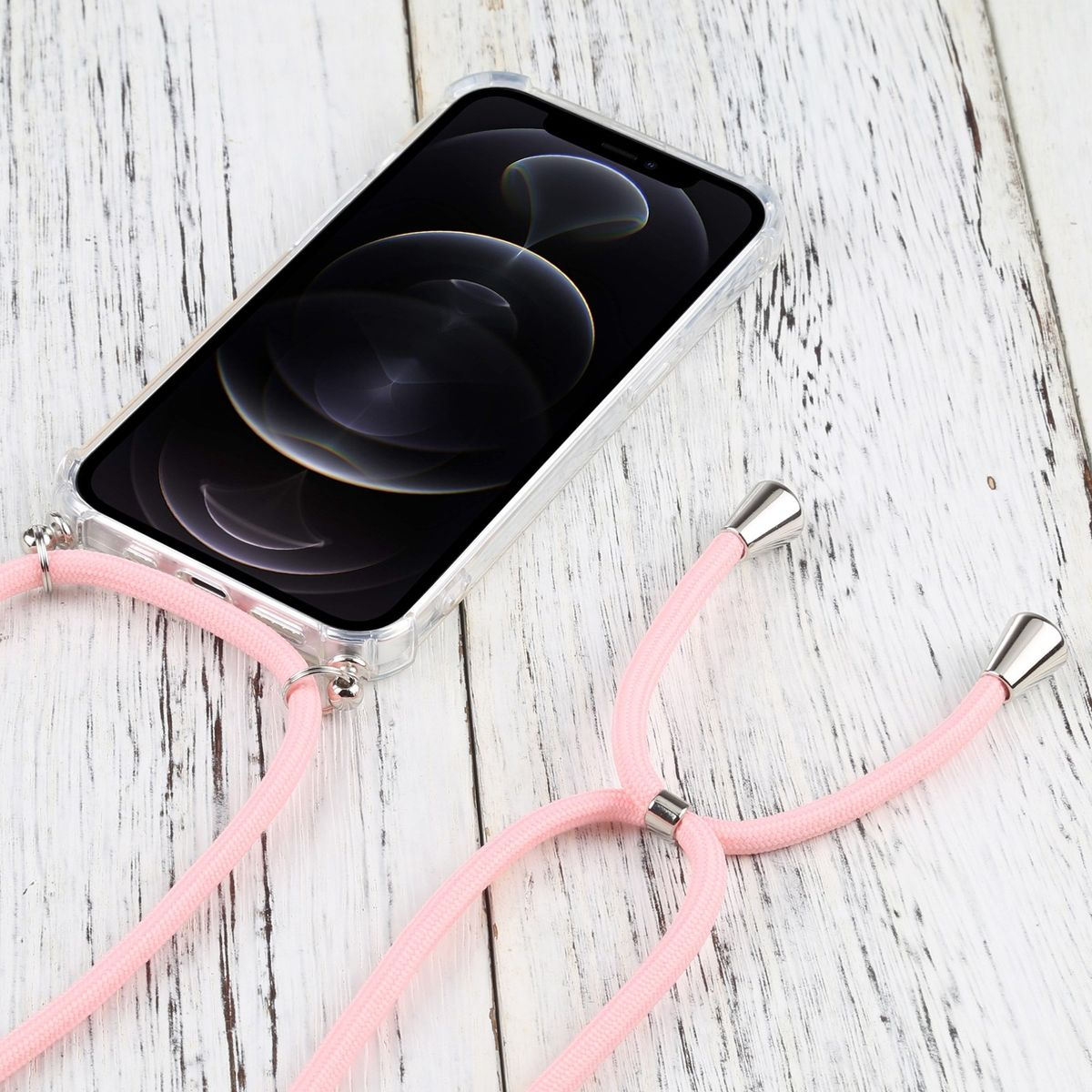 Ein Telefon mit klarer Hülle und rosa Riemen, auf einer Holzoberfläche platziert.