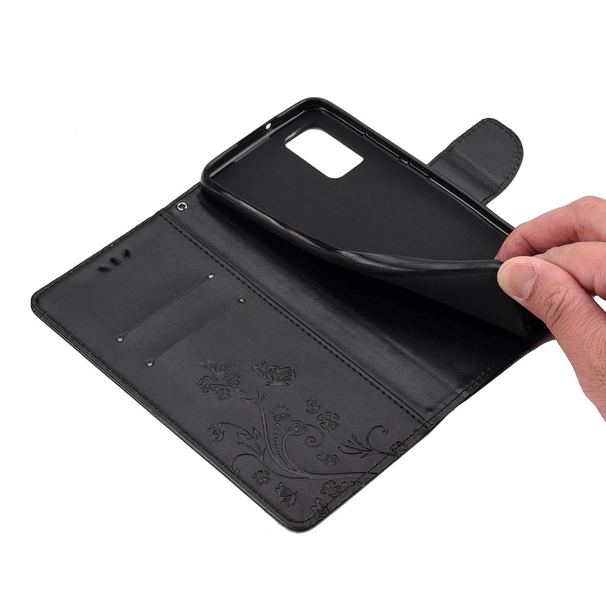 Schwarze Handyhülle, offen, mit einer Hand, die ein Telefon einsetzt. Blumendesign auf dem Gehäuse.