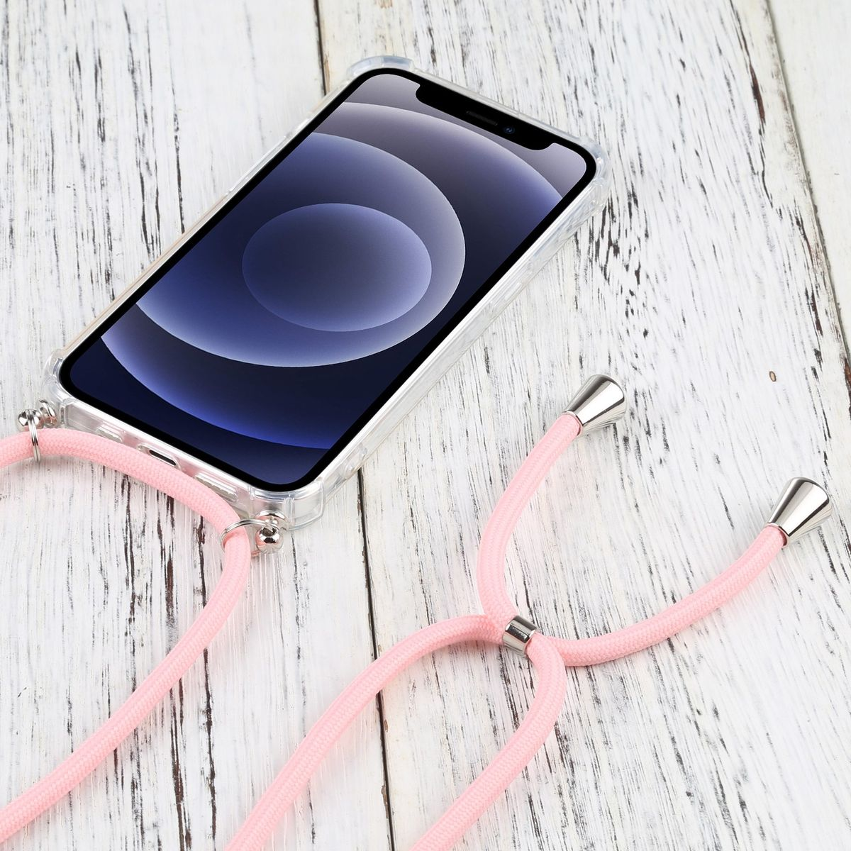 Telefon in klarer Hülle mit pinkfarbenem Lanyard, auf Holzoberfläche liegend.