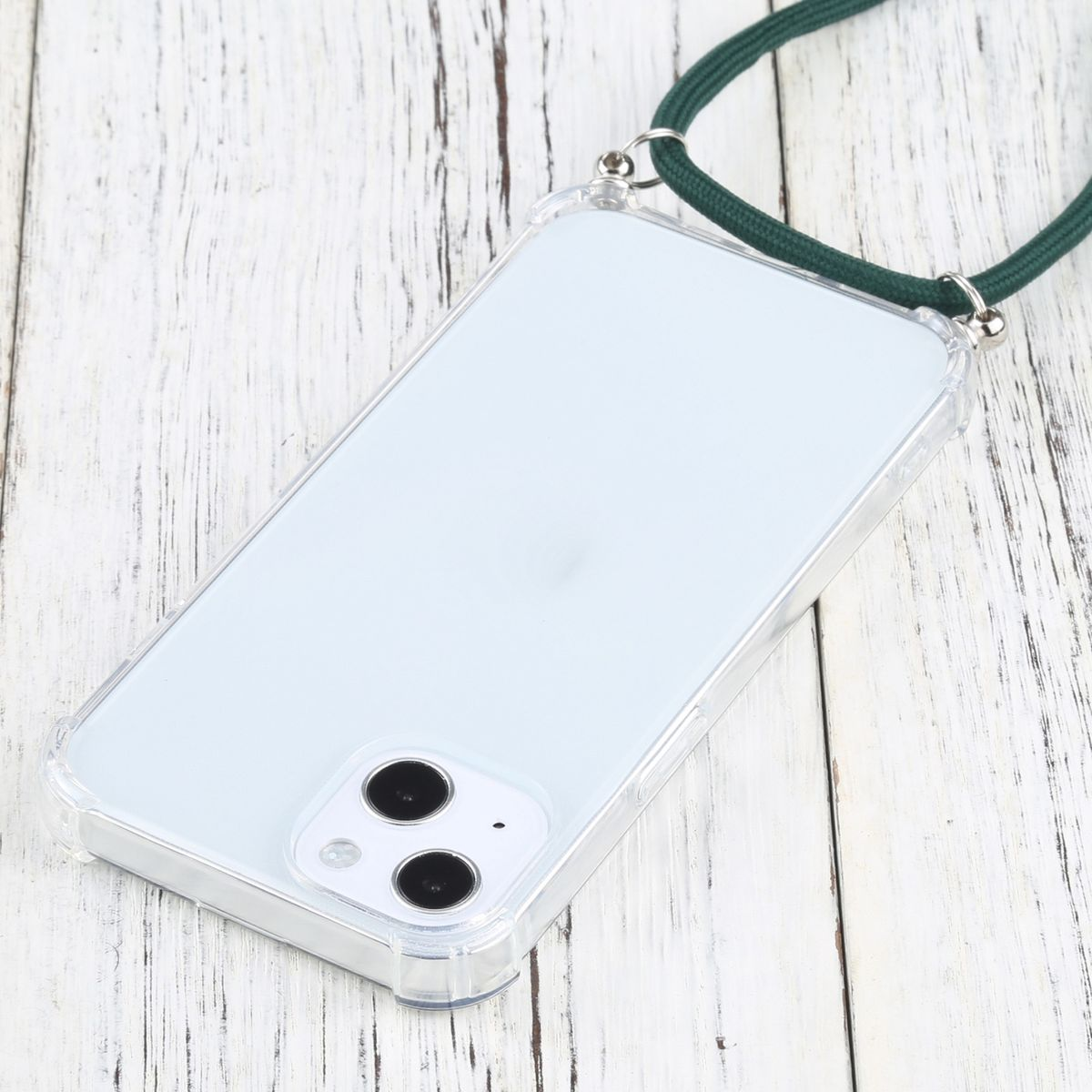 Eine transparente Handyhülle mit grünem Lanyard, Telefon sichtbar, auf einer hellen Holzoberfläche.