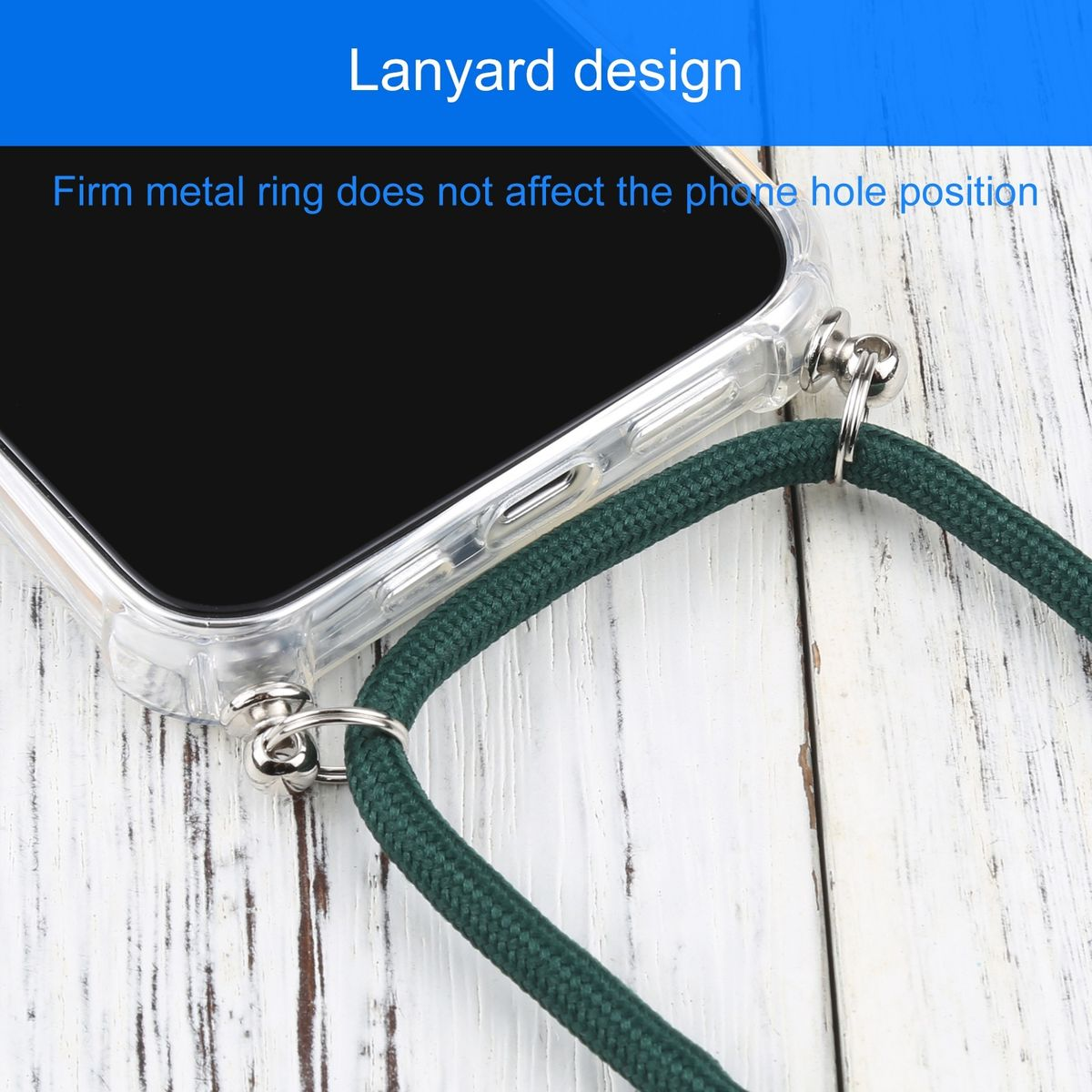 Nahaufnahme eines Telefons mit grünem Lanyard, das an einem Metallring auf Holz befestigt ist.