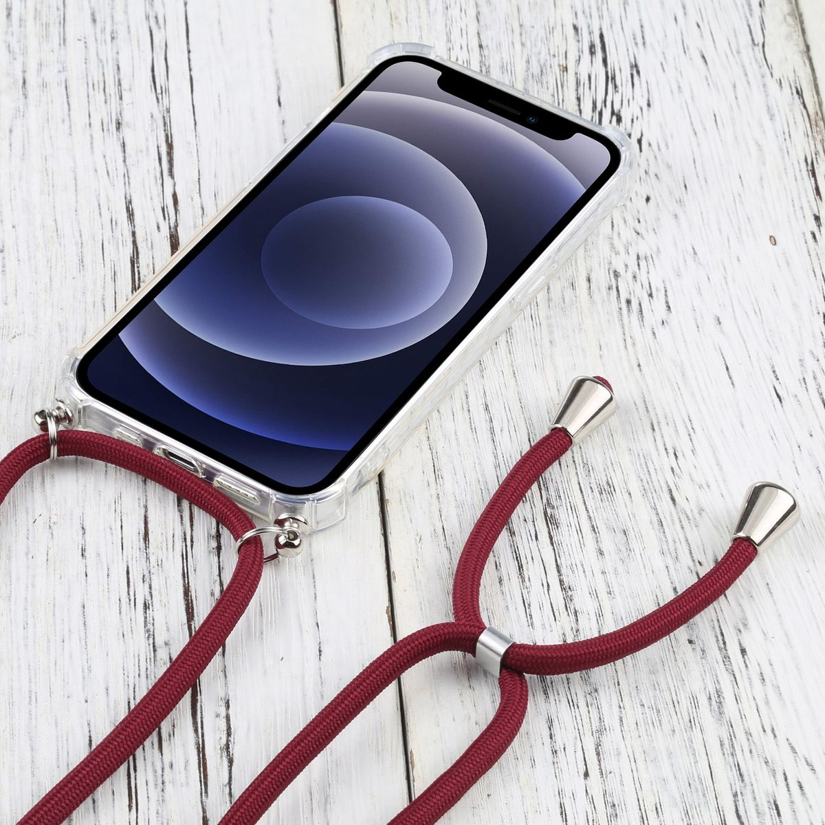 Eine transparente Handyhülle mit roter Kordel. Das Telefon liegt auf einer Holzoberfläche.