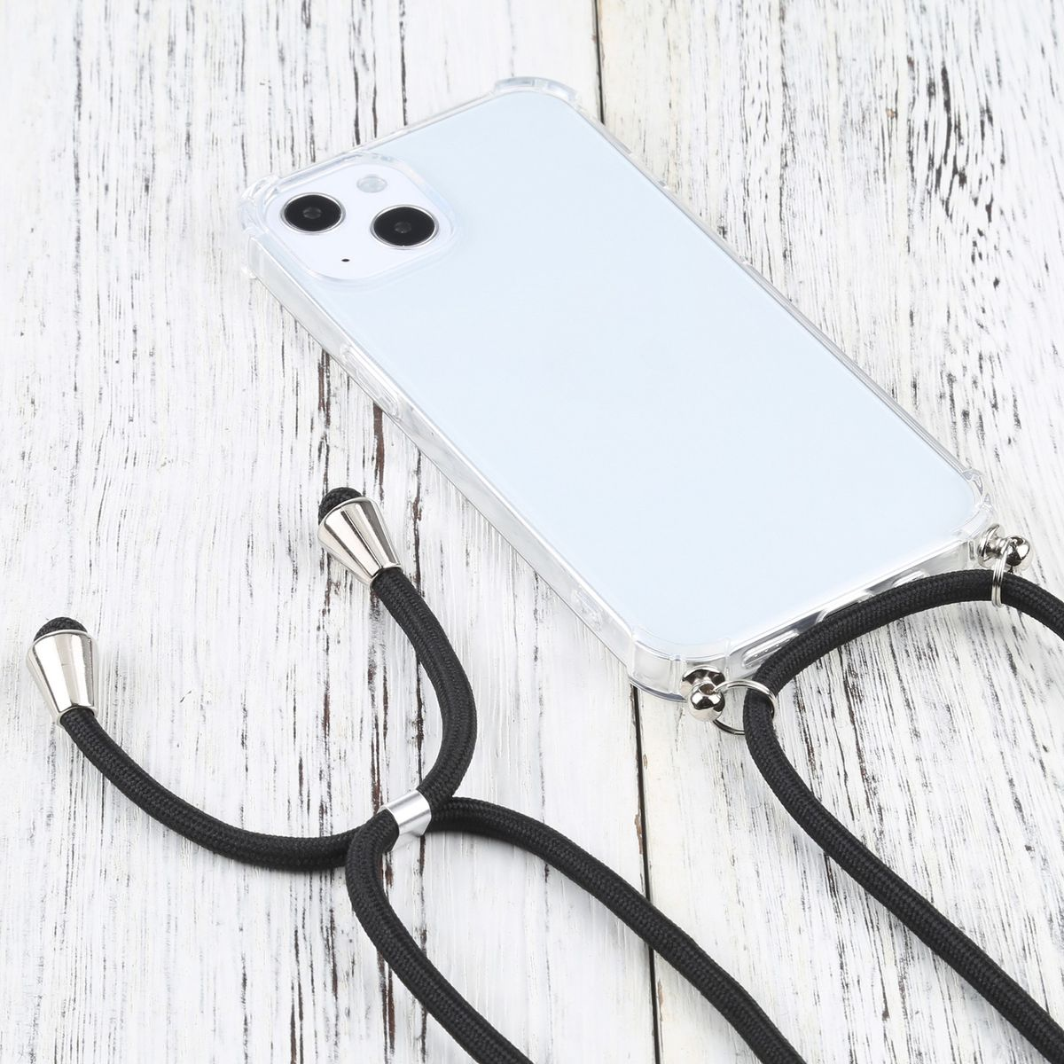 Eine transparente Handyhülle mit schwarzem Kordel. Das Telefon liegt auf Holz.