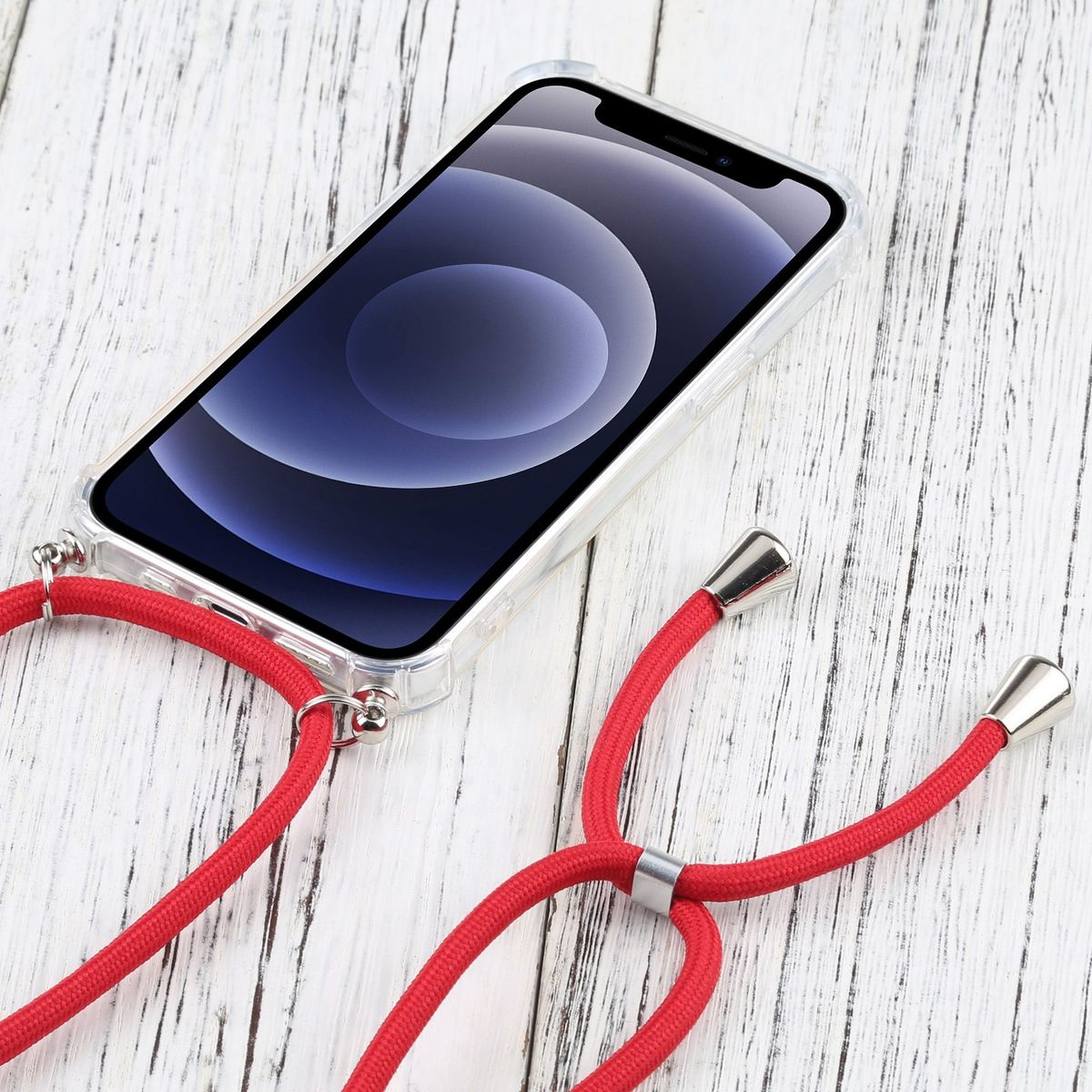 Transparente Handyhülle mit rotem Trageriemen. Das Telefon ist sichtbar und liegt auf einer Holzoberfläche.