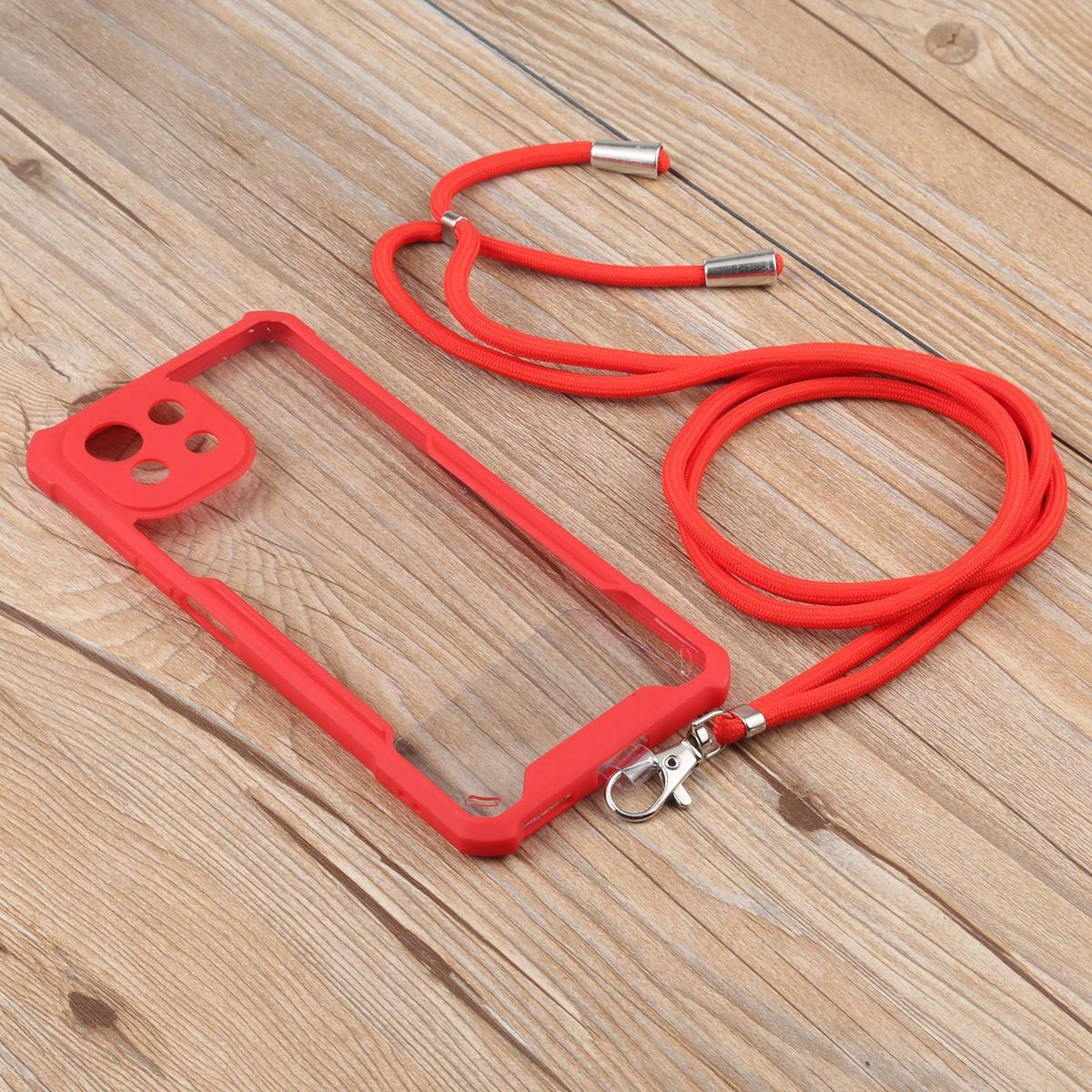 Rote Handyhülle mit rotem Lanyard. Handyhülle ist klar und auf Holzgrund.