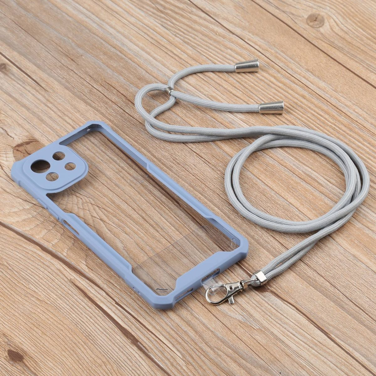 Blaue Handyhülle mit klarer Rückseite, graues Schlüsselband auf Holzoberfläche.