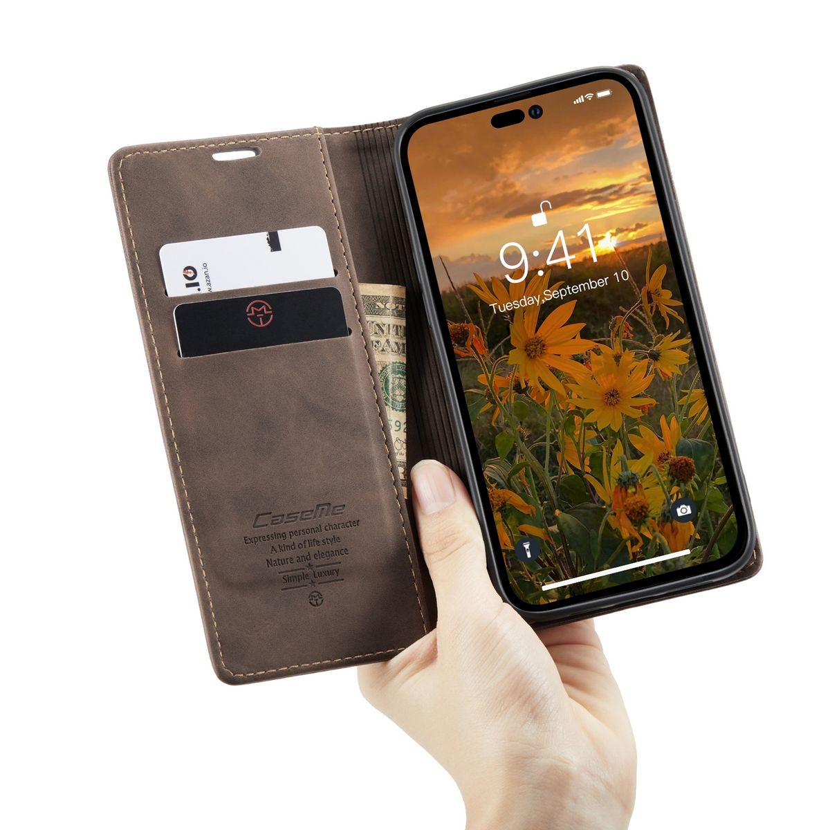 Eine Hand hält eine braune Handyhülle mit einem Telefon darin. Das Telefon zeigt einen Sonnenuntergang.