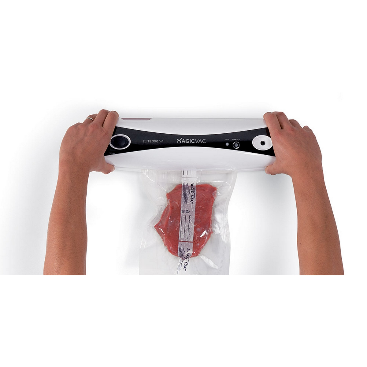 Ręce obsługują zgrzewarkę próżniową. Czerwony stek w przezroczystej plastikowej torbie.