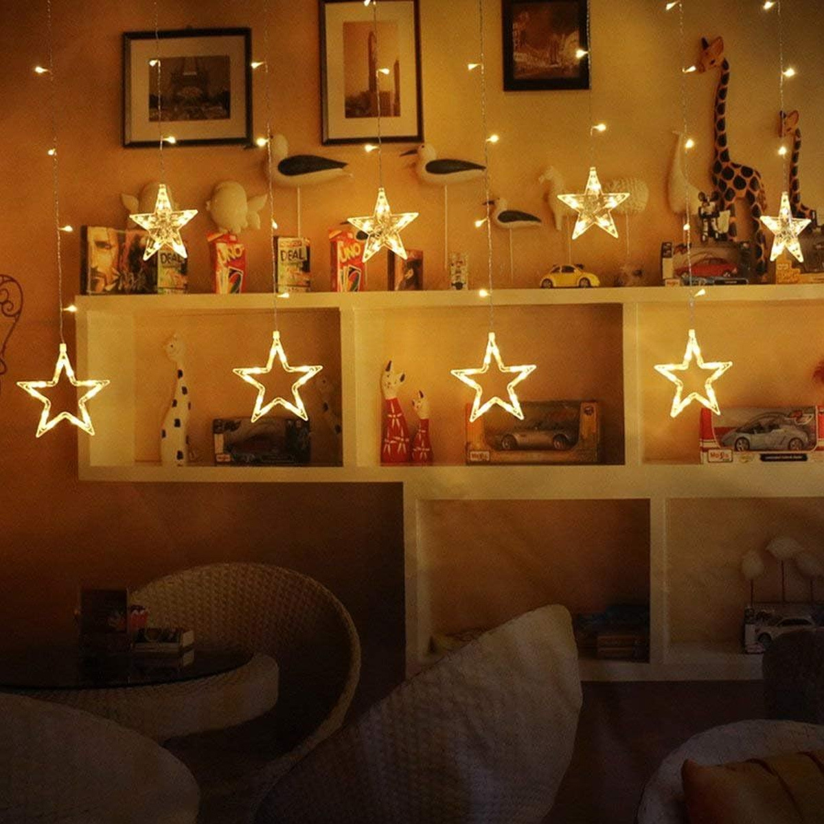 Sternförmige Lichterketten an der Wand, Spielzeug auf Regalen, warme Beleuchtung.