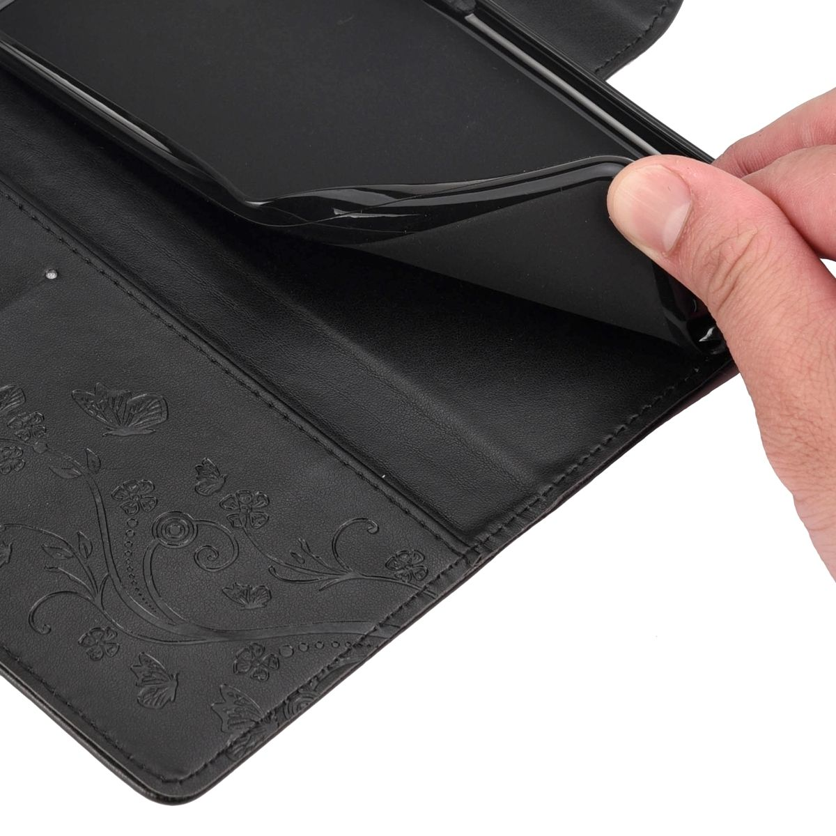 Schwarzes Handyhülleninnere mit Blumendesign und eine Hand, die ein Telefon entfernt.