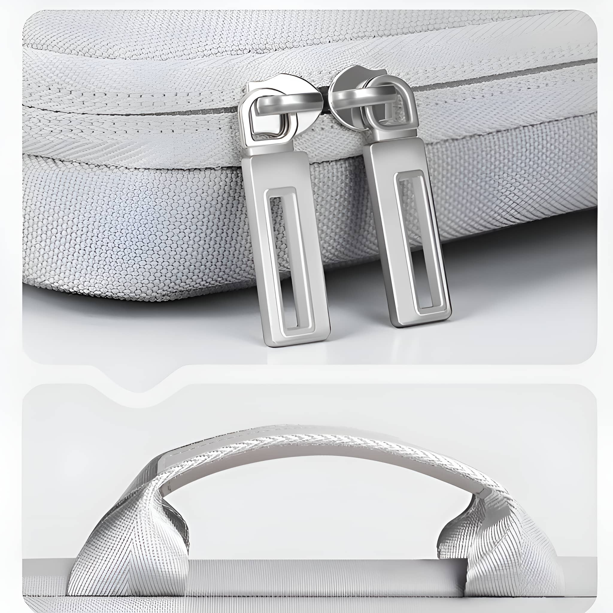 Nahaufnahme von zwei silbernen Reißverschlüssen auf einer weißen Tasche. Darunter ein weißer Griff an einer weißen Tasche.