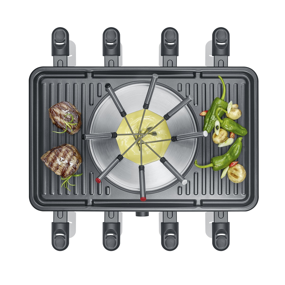 Grill do raclette z serem, warzywami i mięsem. Różne elementy są ułożone na powierzchni.