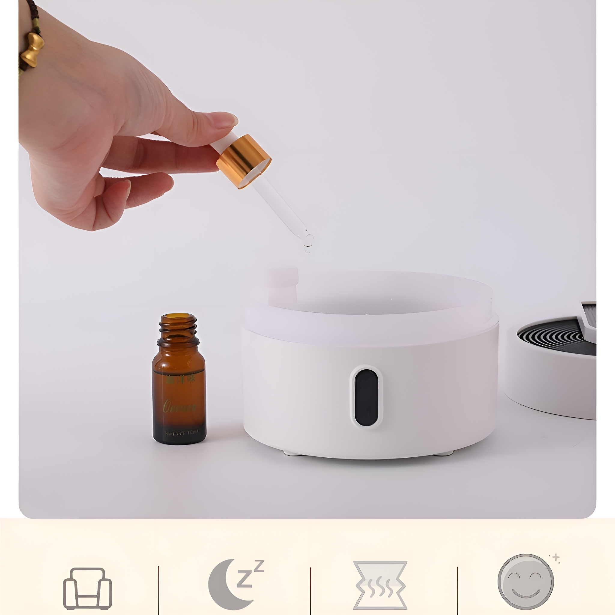 Aromatherapie-Diffusor mit einer Hand, die Öl einfüllt, mit Symbolen darunter, auf weißer Oberfläche.