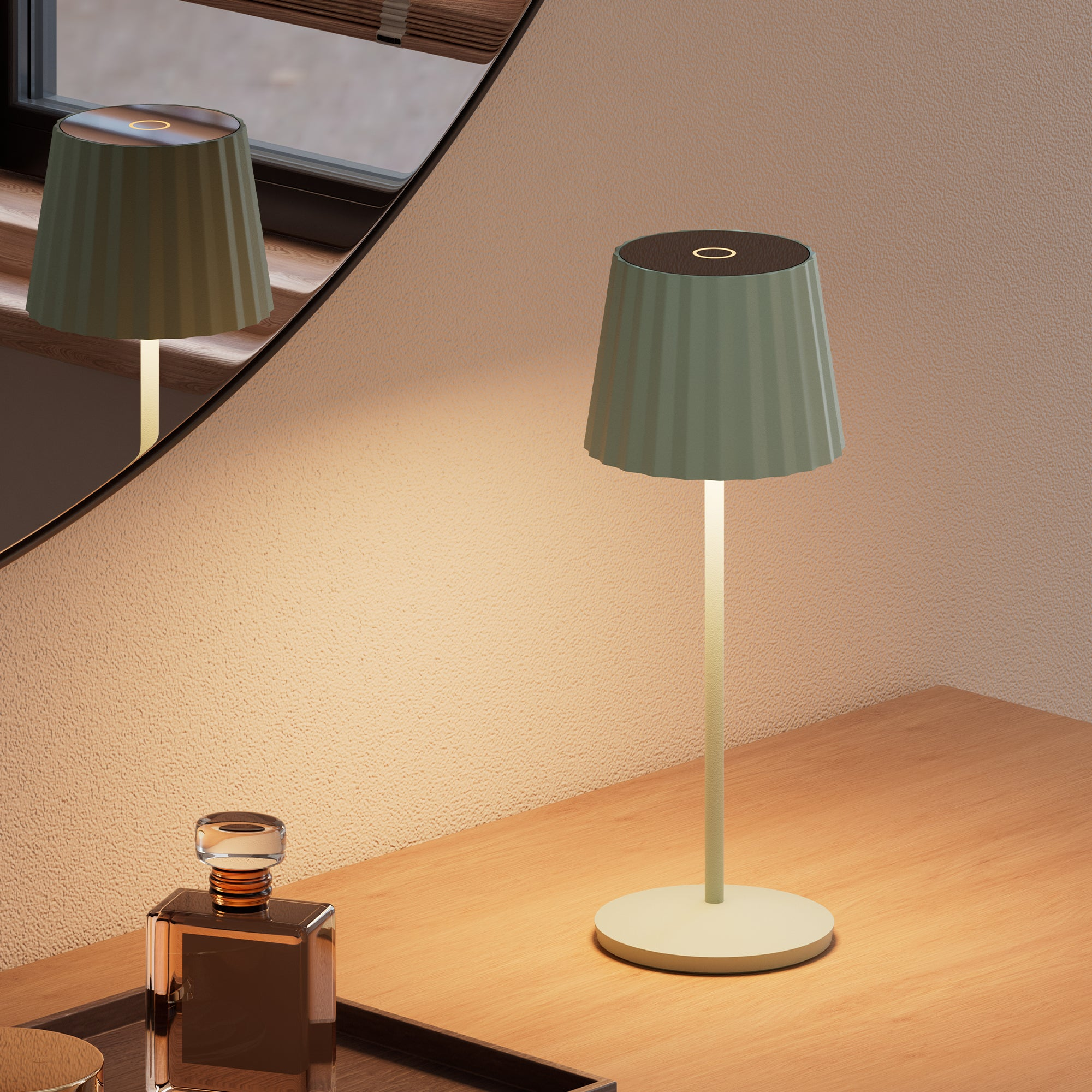Grüne Tischlampe mit rundem Fuß und Licht auf einem Holztisch.