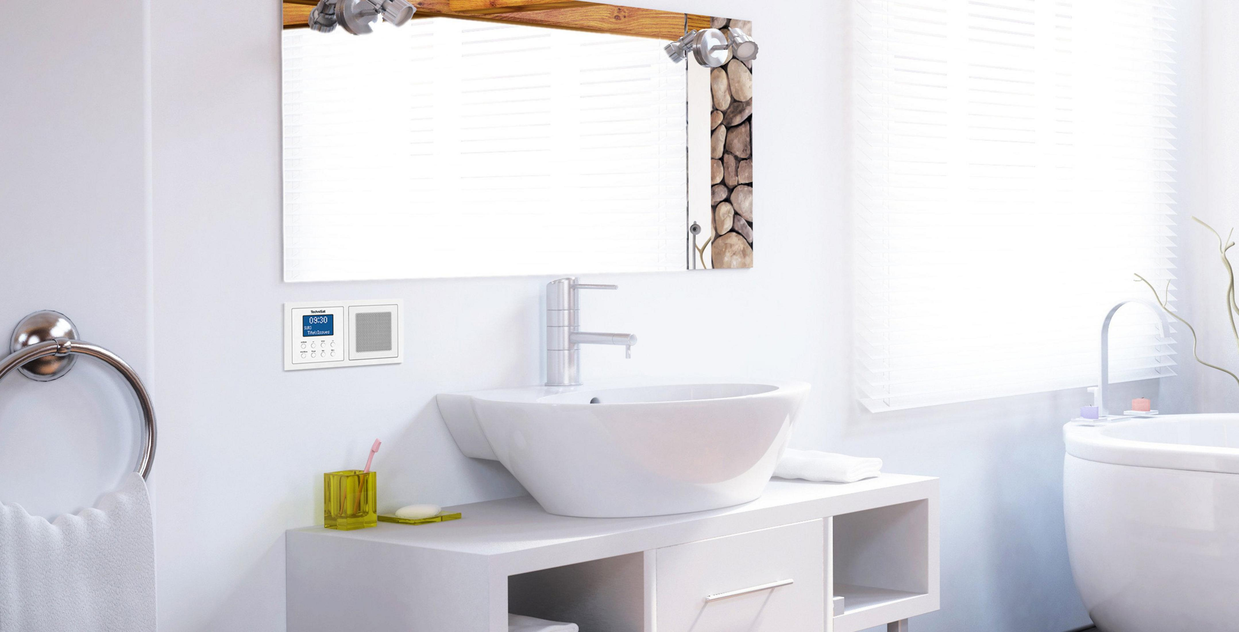 Salle de bain avec lavabo, miroir et radio. Murs blancs, stores et un aperçu d'une baignoire.