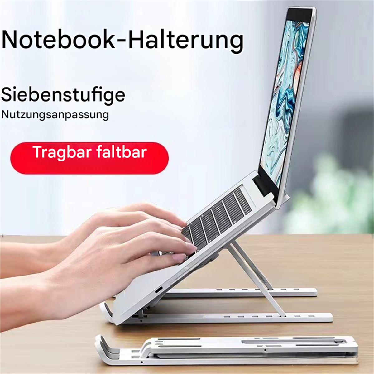 Laptop auf einem silbernen Ständer. Text zeigt 'Notebook-Halterung' und 'Tragbar faltbar'.