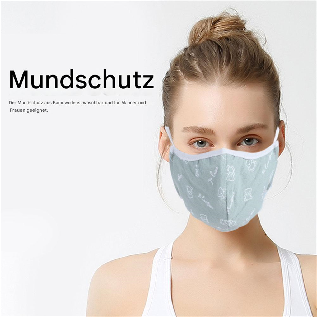 Frau trägt hellgrüne Gesichtsmaske mit weißen Bärenmustern. Text: 'Mundschutz' (Gesichtsmaske).