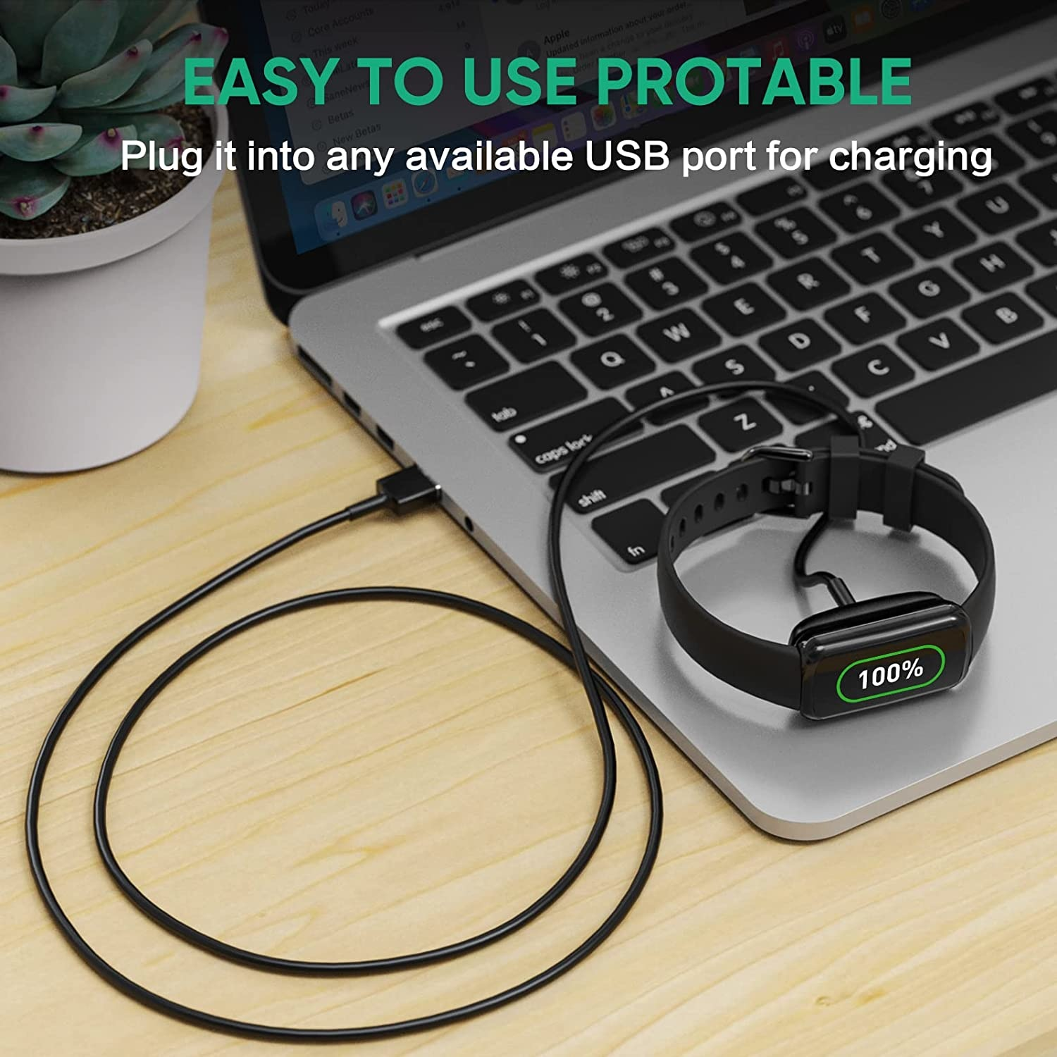 Eine schwarze Smartwatch, die an einem Laptop aufgeladen wird. Das Armband ist mit einem USB-Anschluss verbunden.