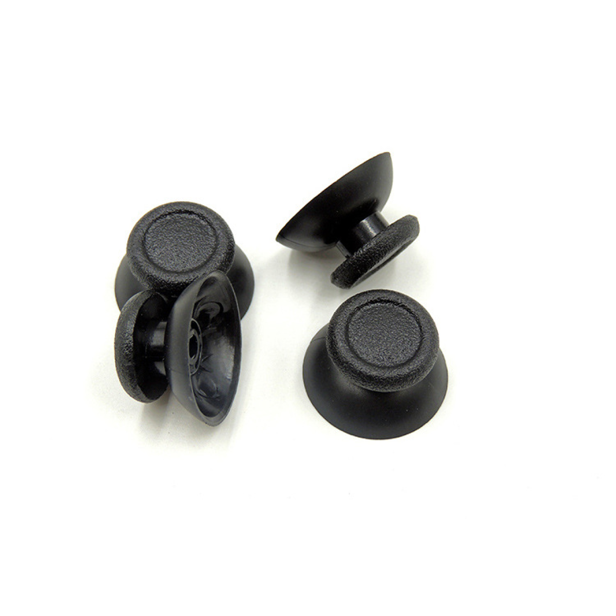 Four black joystick thumbsticks on a white background. They are made of rubber.