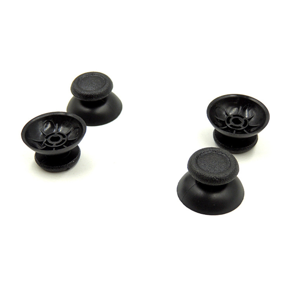 Four black joystick thumbsticks on a white surface. Two are on top of the other two.