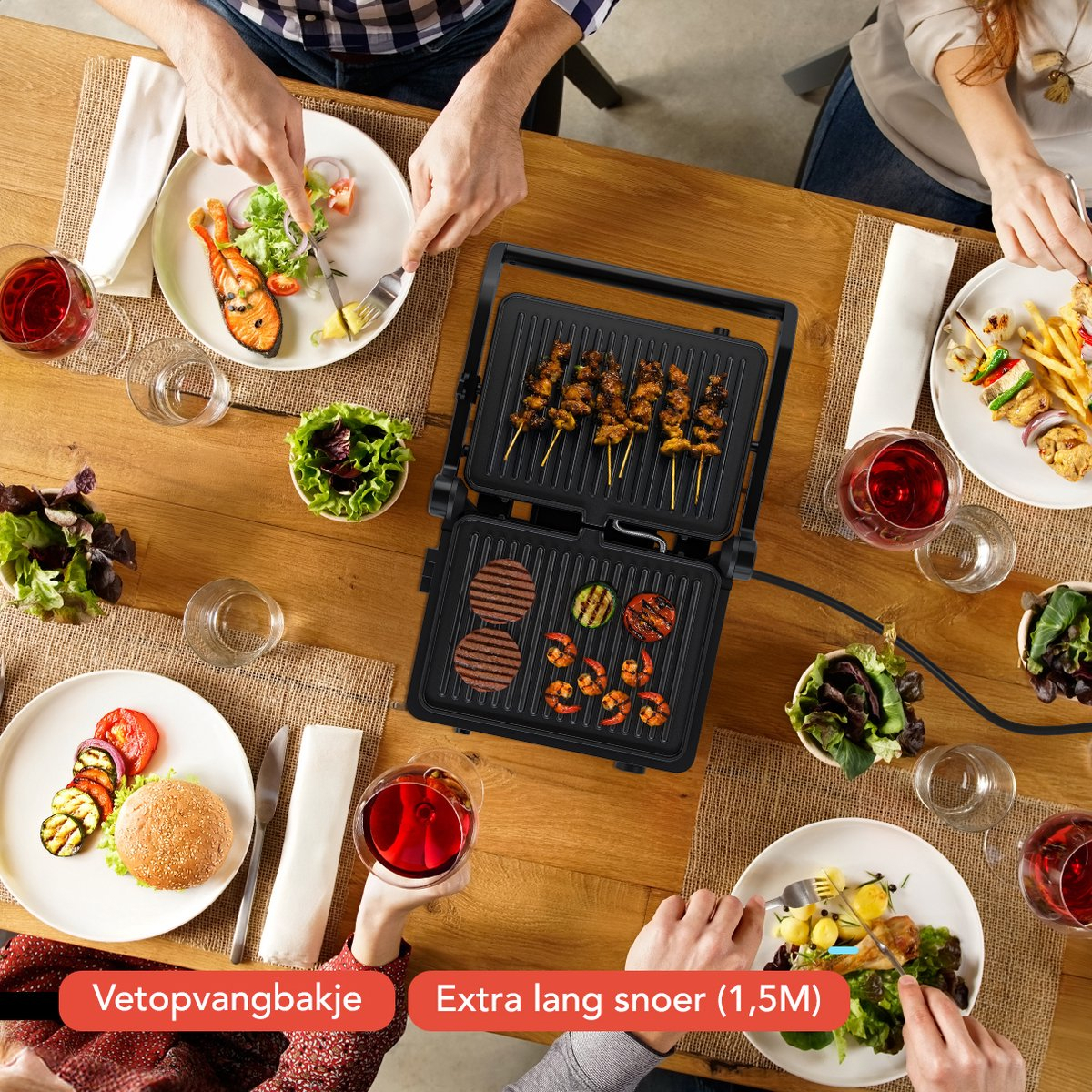 Table with people eating. Includes a grill with food, plates with food, and red wine.