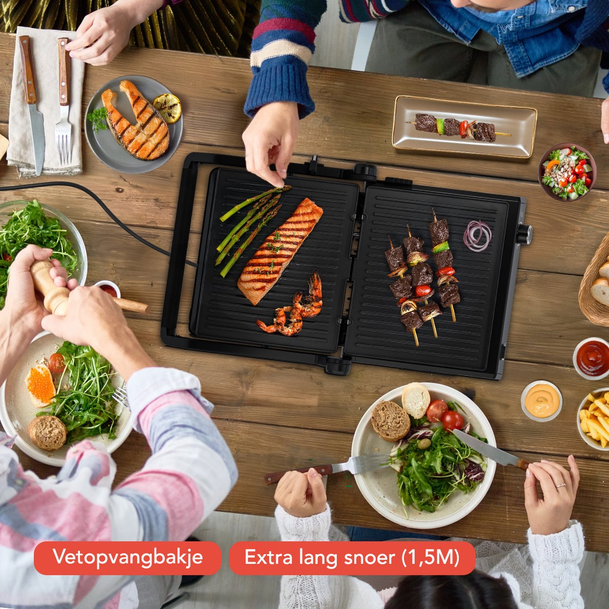 A table with people grilling food on a grill, with various side dishes.